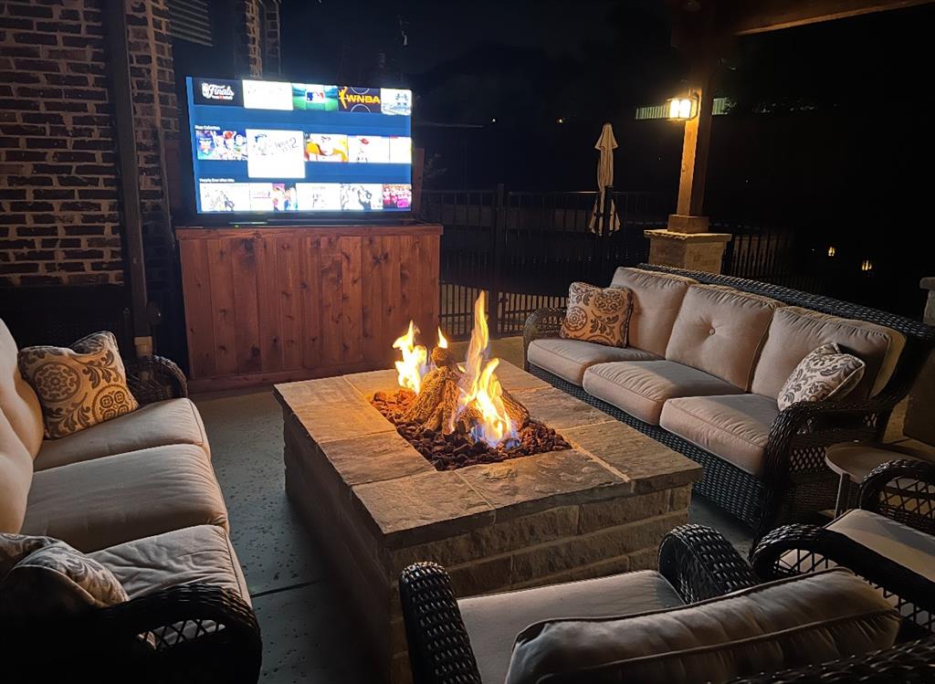 900 Jessica Lane Prosper, TX 75078 - Photo 34 of 40 Firepit at night and TV
