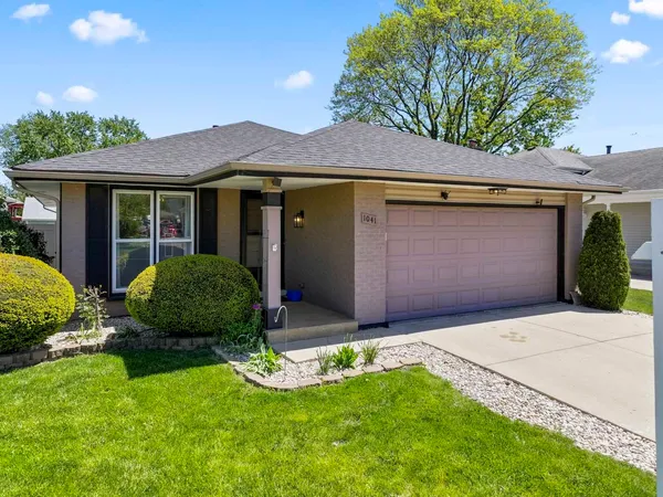 a view of a house with a yard and garage