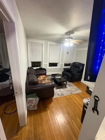 a living room with furniture and a mirror