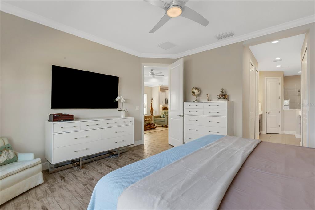 3325 Azurite Way Lakewood Ranch, FL 34211 - Photo 19 of 46 a room with a bed and flat screen tv