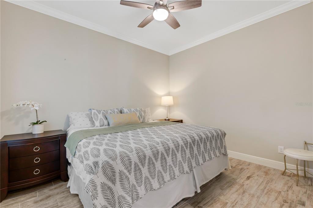 3325 Azurite Way Lakewood Ranch, FL 34211 - Photo 24 of 46 a bedroom with a bed and a chandelier