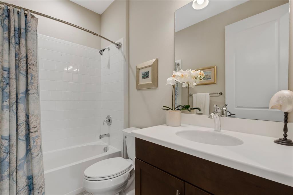 3325 Azurite Way Lakewood Ranch, FL 34211 - Photo 25 of 46 a bathroom with a bathtub shower sink vanity mirror and toilet