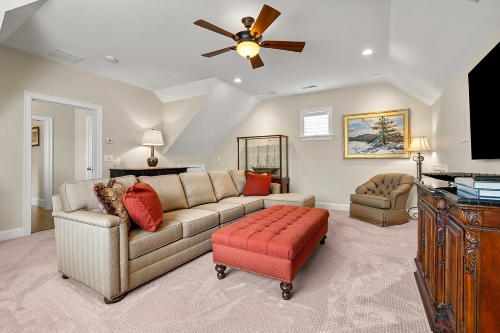 4 Point Shore Overlook Amesbury, MA 01913 - Photo 30 of 42 a living room with furniture a flat screen tv and a ceiling fan