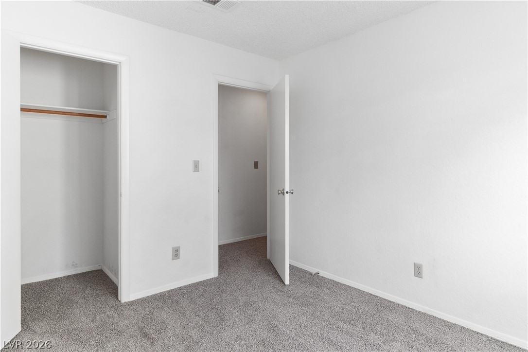 2146 High Dunes Lane Laughlin, NV 89029 - Photo 33 of 64 Second bedroom featuring carpet flooring, a closet, and baseboards
