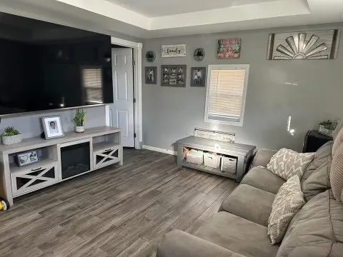 a living room with furniture and a flat screen tv