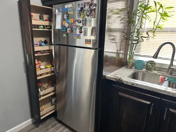 a kitchen with a refrigerator and a sink
