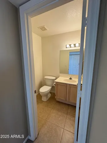 a bathroom with a sink a toilet and mirror