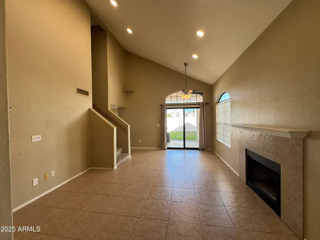 a view of a hall with stairs and a fireplace
