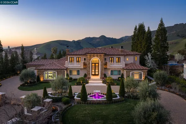a front view of residential houses with outdoor space and trees