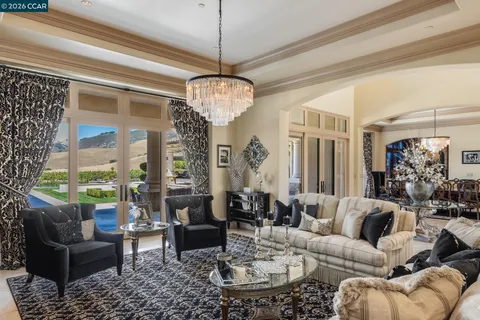 a kitchen with granite countertop a sink a counter top space and living room view