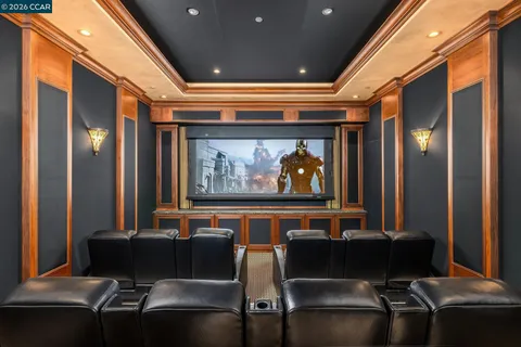 a living room with furniture a chandelier and a fireplace