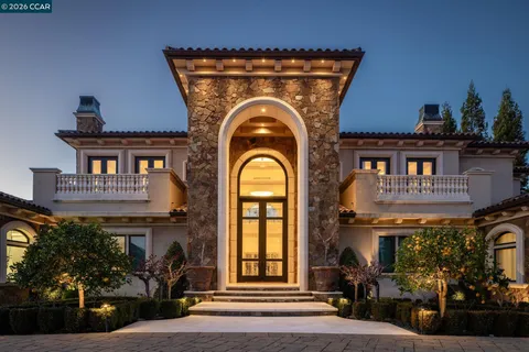 a front view of a house with garden and patio