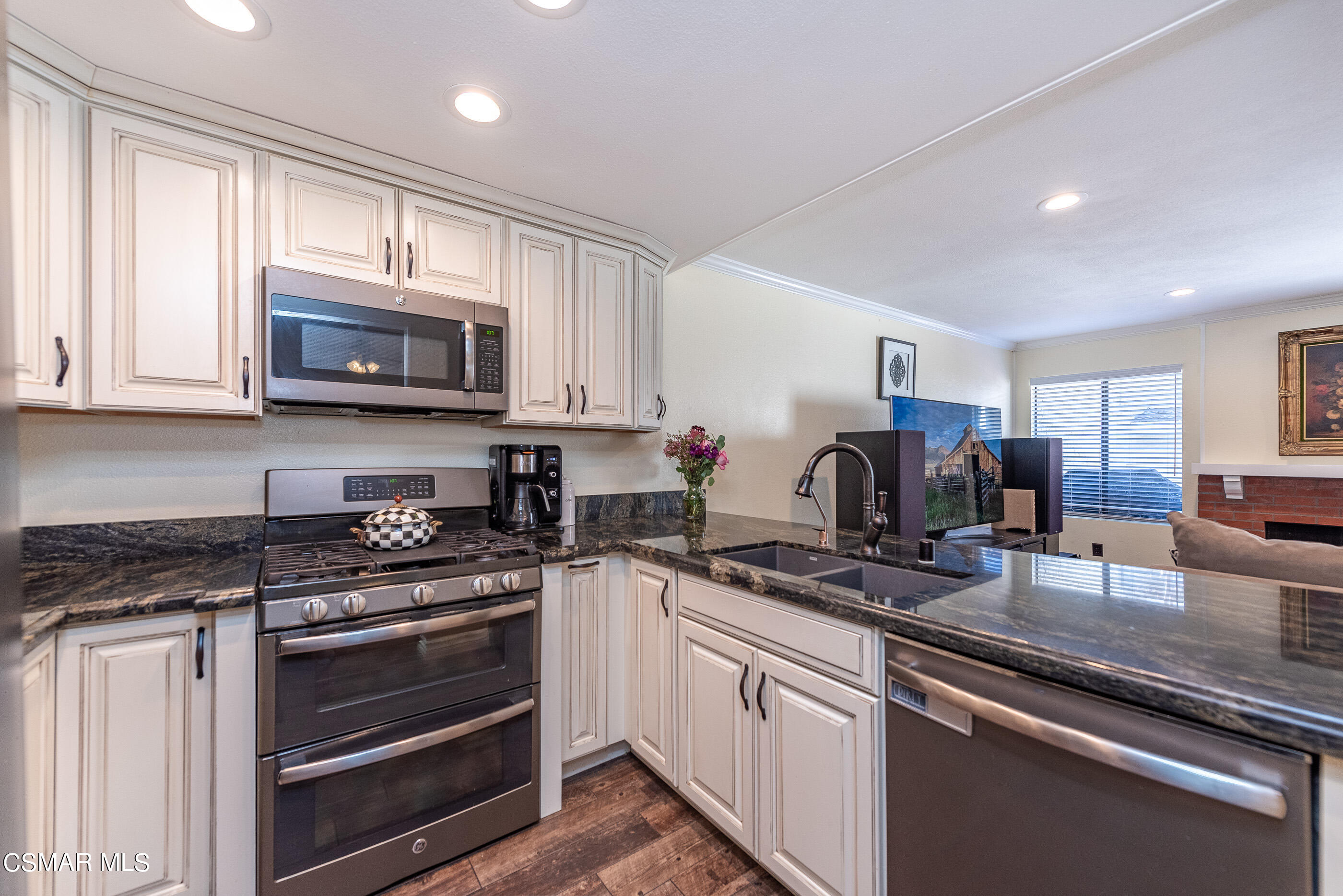 1928 Stow Street Simi Valley, CA 93063 - Photo 11 of 31 a kitchen with granite countertop a sink stove and microwave