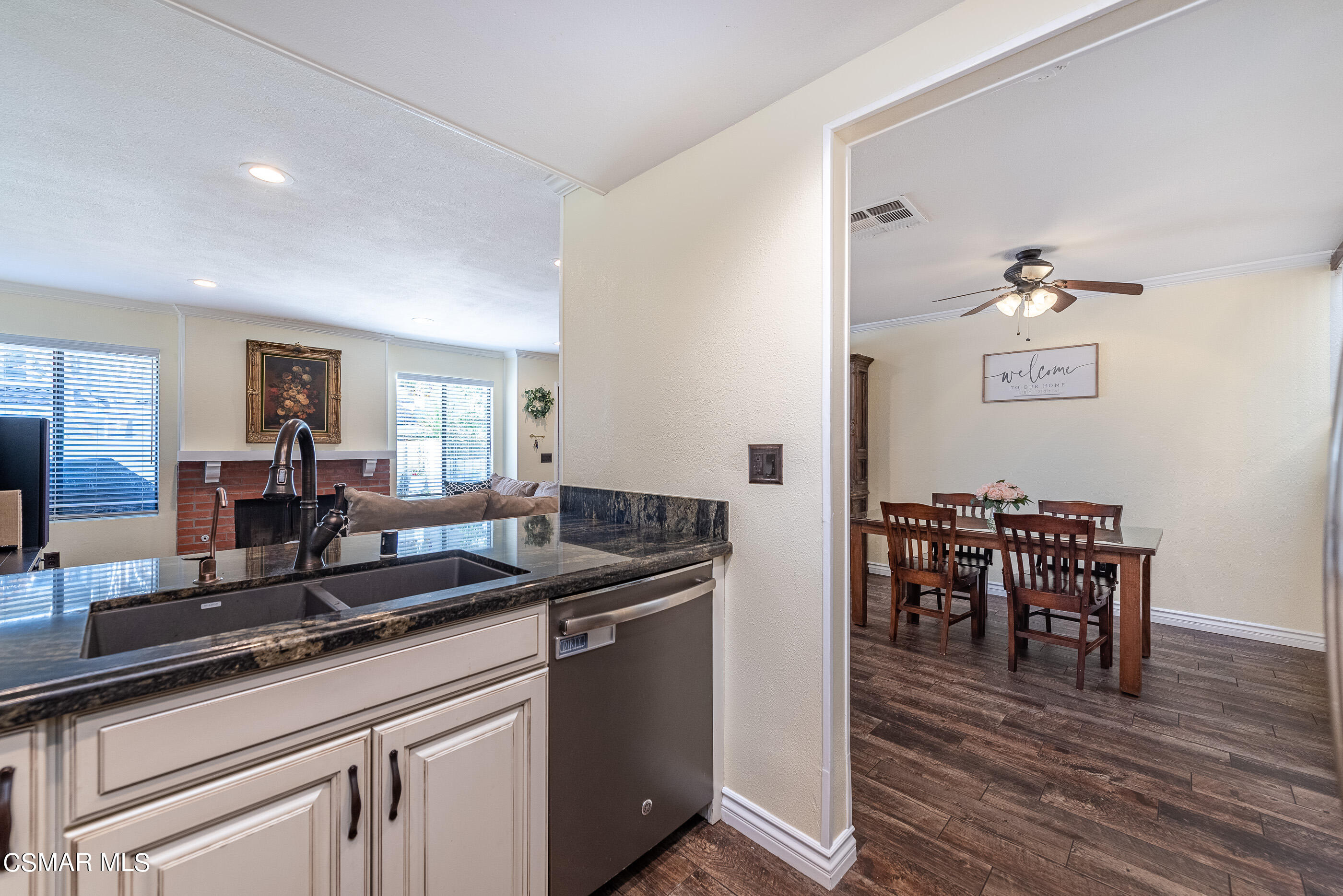 1928 Stow Street Simi Valley, CA 93063 - Photo 13 of 31 a kitchen with a table chairs and wooden floor