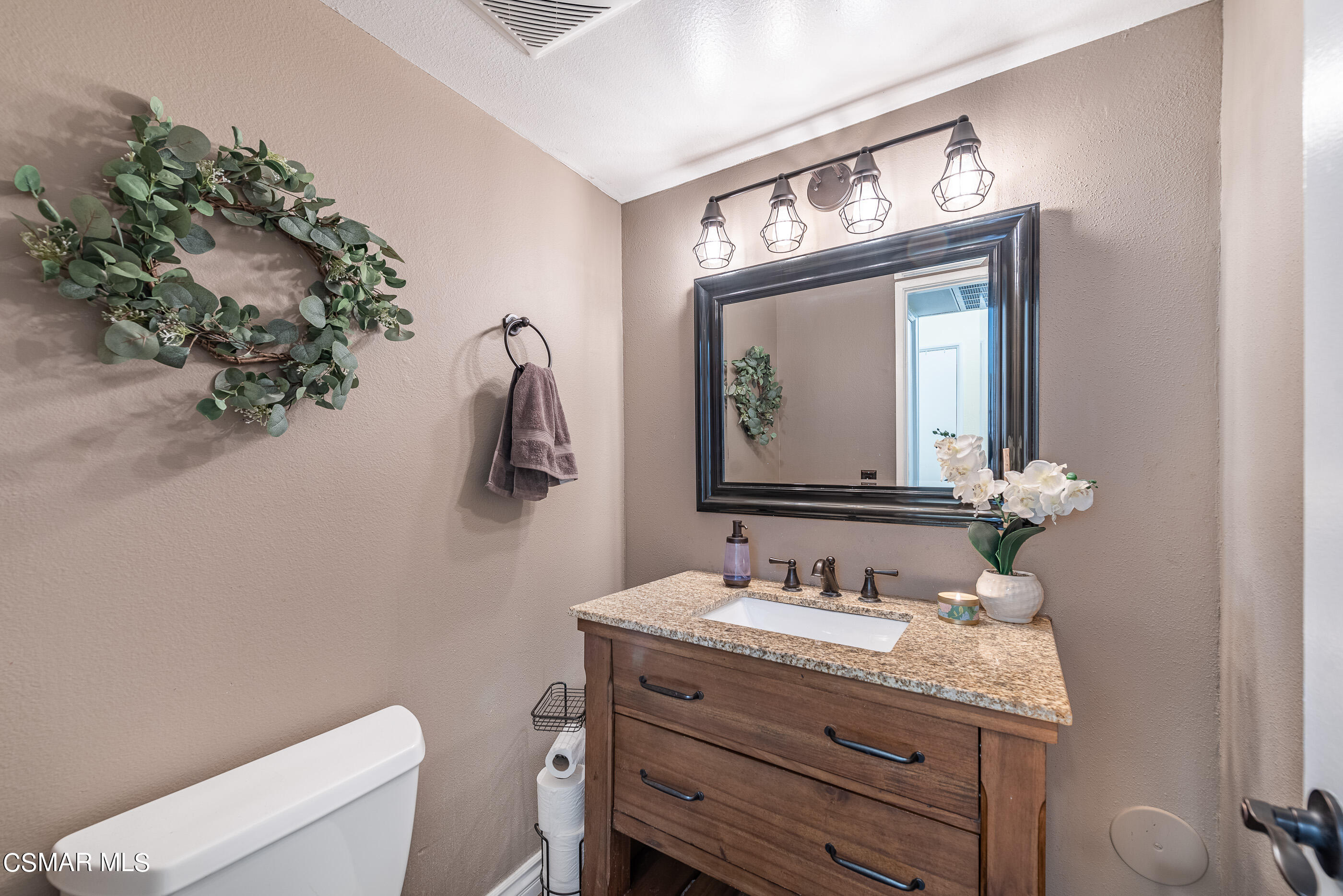 1928 Stow Street Simi Valley, CA 93063 - Photo 14 of 31 a bathroom with a granite countertop toilet sink and mirror