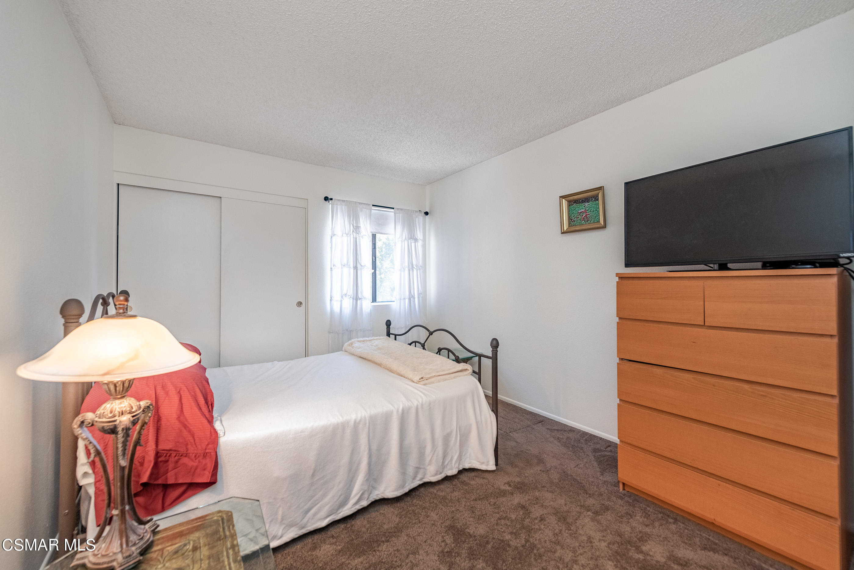 1928 Stow Street Simi Valley, CA 93063 - Photo 23 of 31 a bedroom with a bed and a flat screen tv