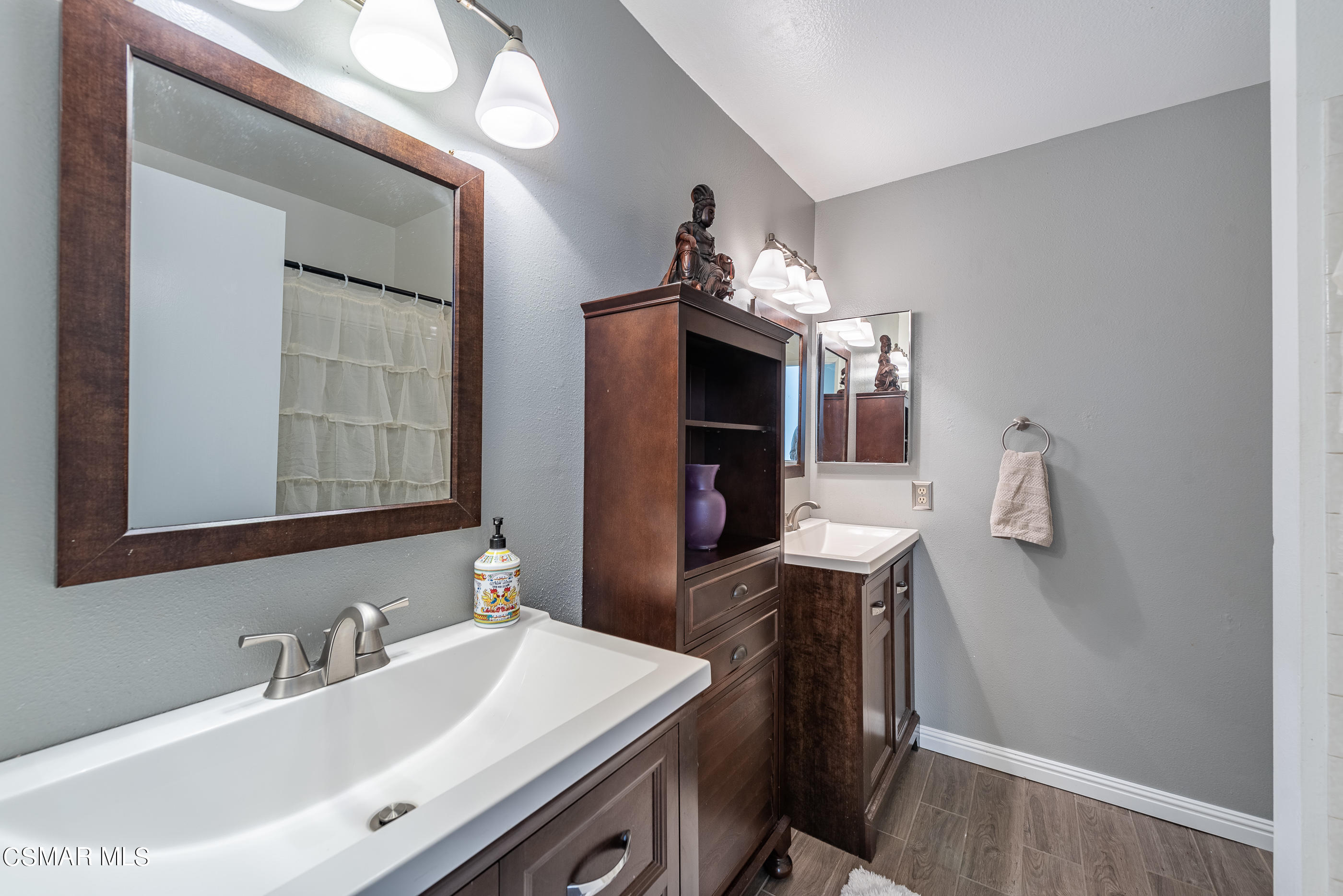 1928 Stow Street Simi Valley, CA 93063 - Photo 24 of 31 a bathroom with a sink vanity and a mirror