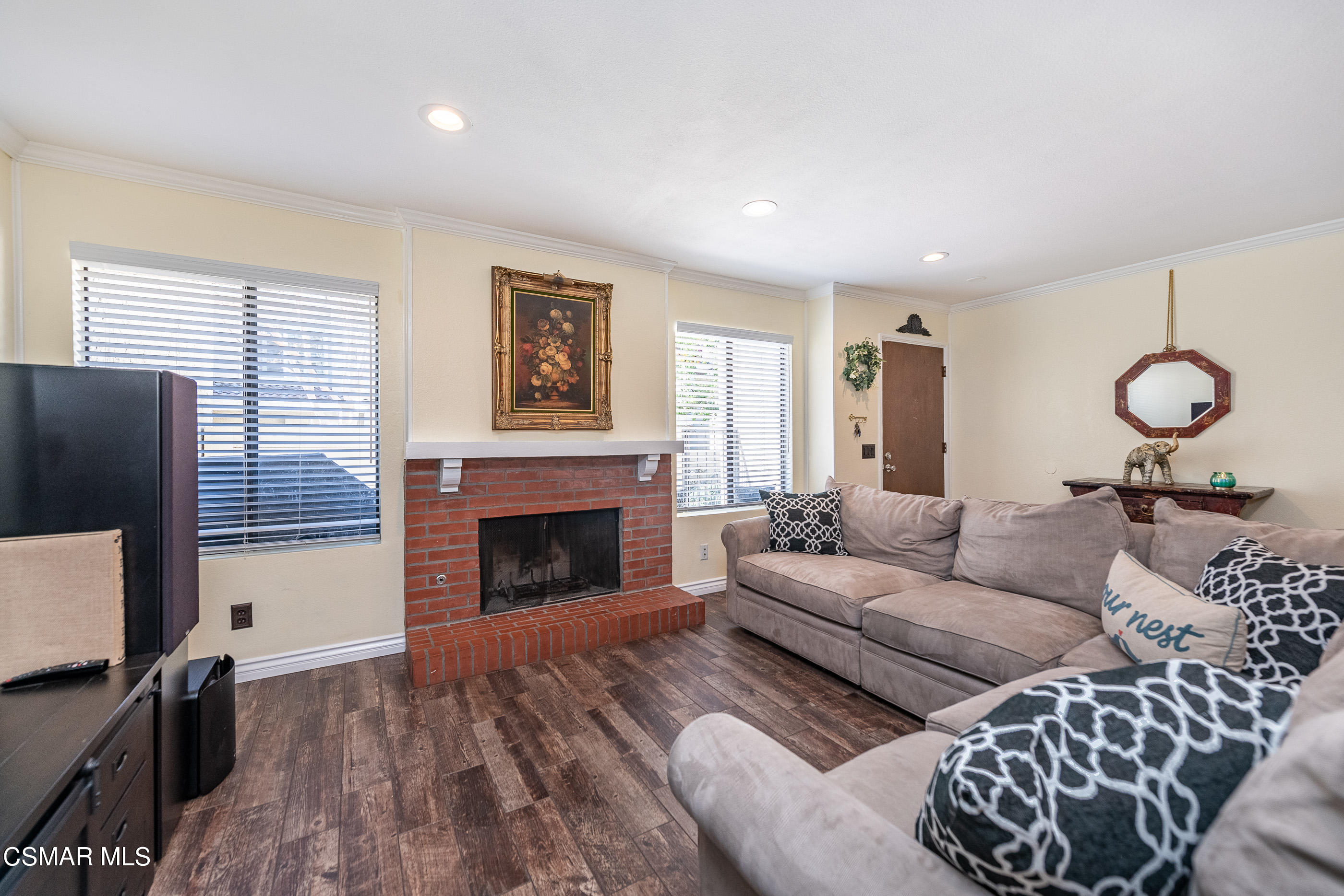 1928 Stow Street Simi Valley, CA 93063 - Photo 7 of 31 a living room with furniture a fireplace and a flat screen tv