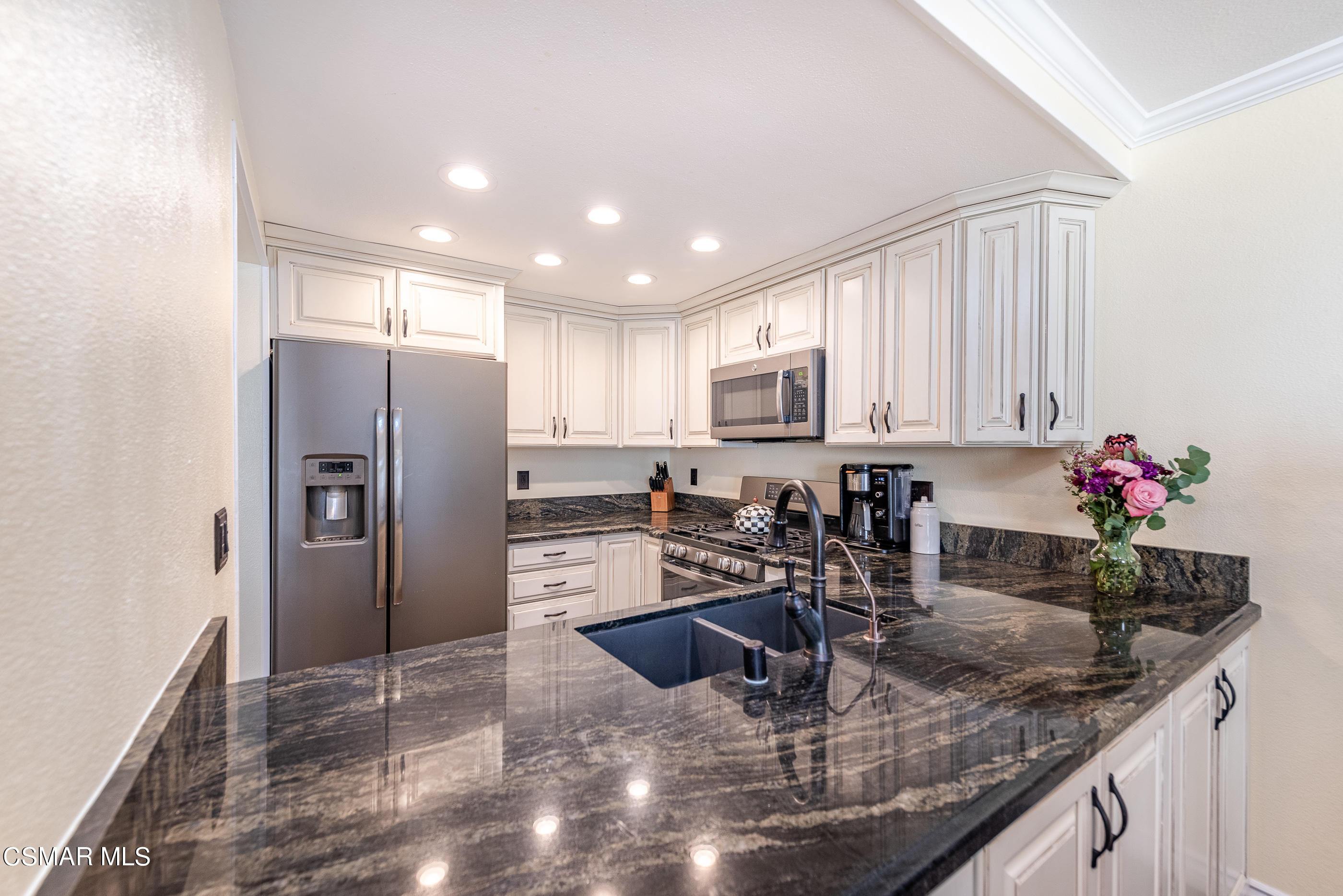 1928 Stow Street Simi Valley, CA 93063 - Photo 10 of 31 a kitchen with stainless steel appliances granite countertop a sink refrigerator and cabinets