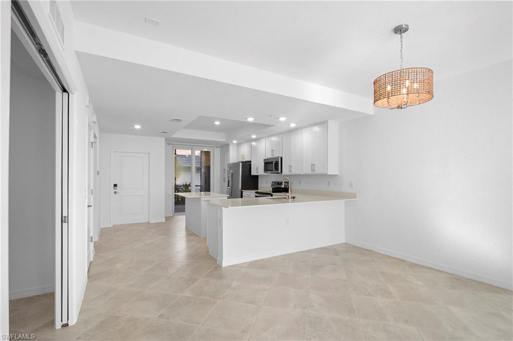 15155 Bluffton Lane, Unit 517 Babcock Ranch, FL 33982 - Photo 11 of 39 a view of kitchen with refrigerator stove and microwave