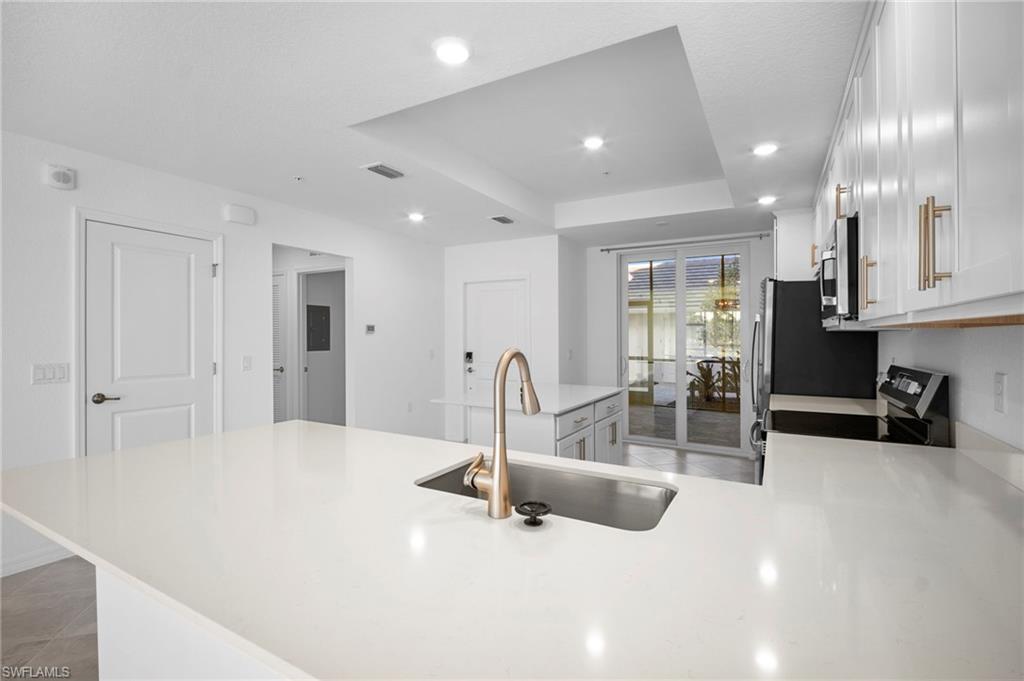 15155 Bluffton Lane, Unit 517 Babcock Ranch, FL 33982 - Photo 11 of 39 a swimming pool with glass table and chairs