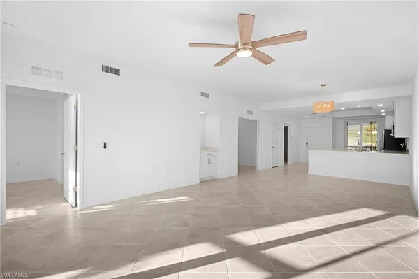 an empty room with windows and natural light