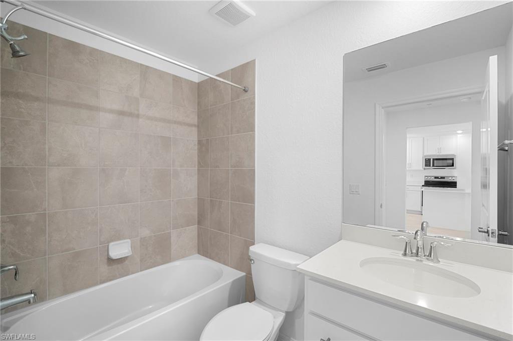 15155 Bluffton Lane, Unit 517 Babcock Ranch, FL 33982 - Photo 27 of 39 a bathroom with a sink toilet and shower