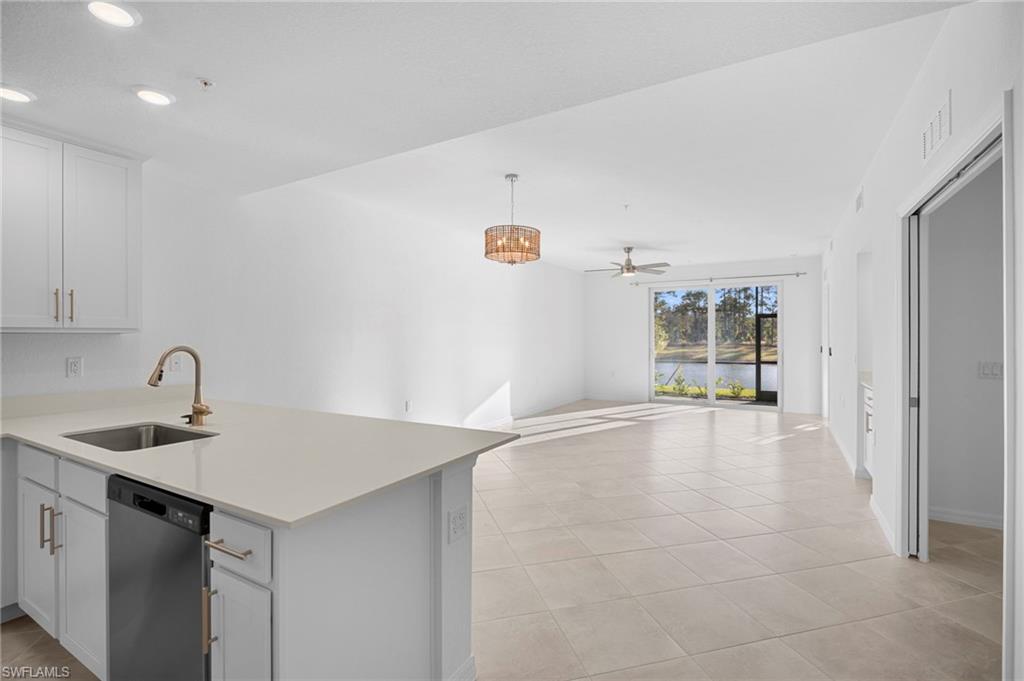 15155 Bluffton Lane, Unit 517 Babcock Ranch, FL 33982 - Photo 3 of 39 a view of a kitchen island a sink wooden floor and a cabinet