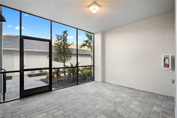 a view of a kitchen island a sink wooden floor and a cabinet