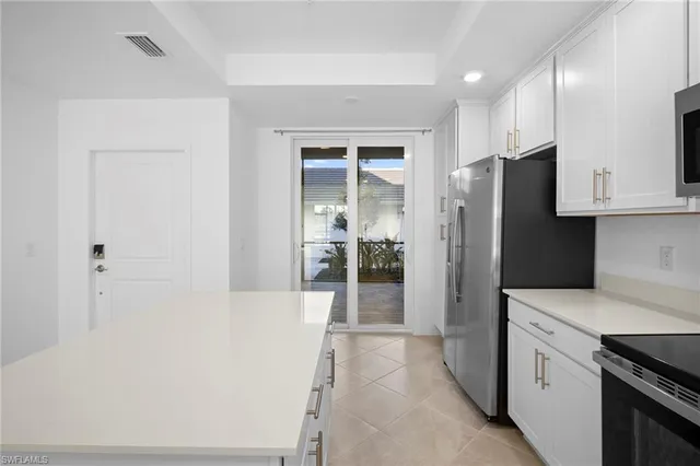 a kitchen with stainless steel appliances granite countertop a refrigerator and a stove