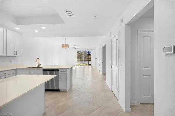 a kitchen with stainless steel appliances granite countertop a refrigerator and a stove