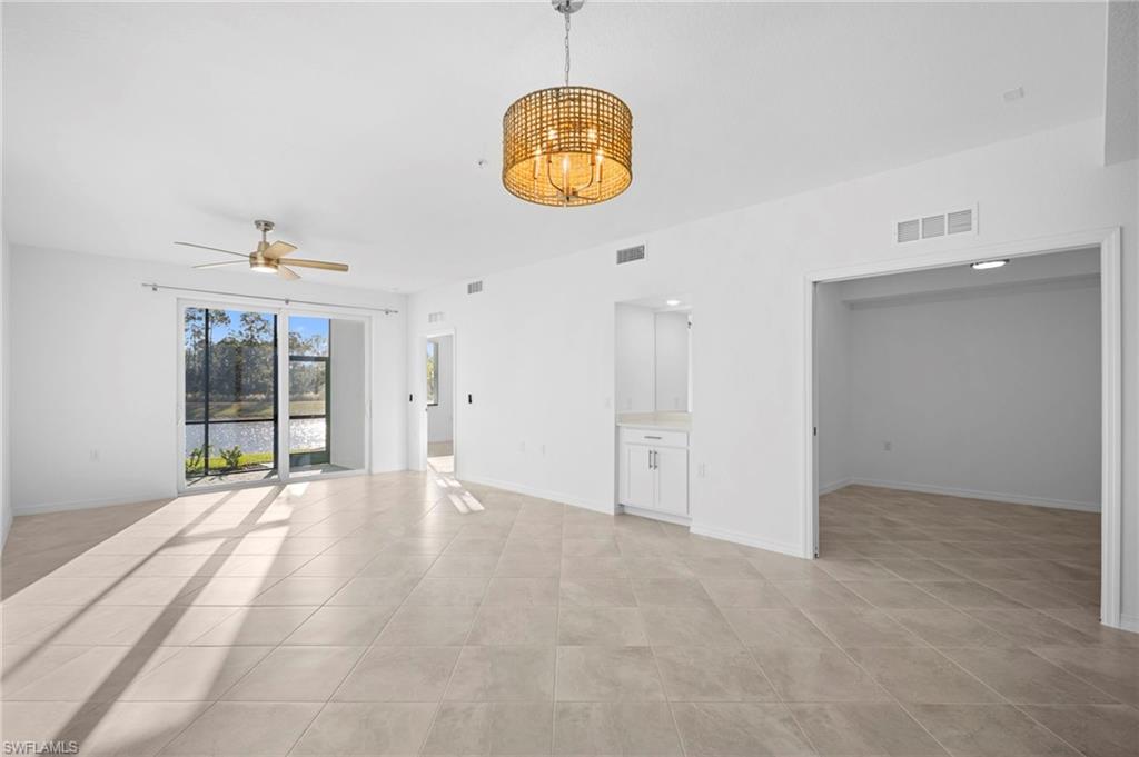 15155 Bluffton Lane, Unit 517 Babcock Ranch, FL 33982 - Photo 10 of 39 an empty room with window and a chandelier