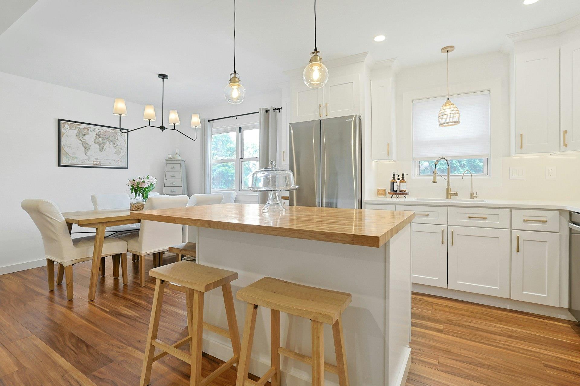 a kitchen with a table chairs sink and cabinets