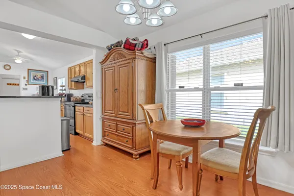 a view of a dining room with furniture window and wooden floor