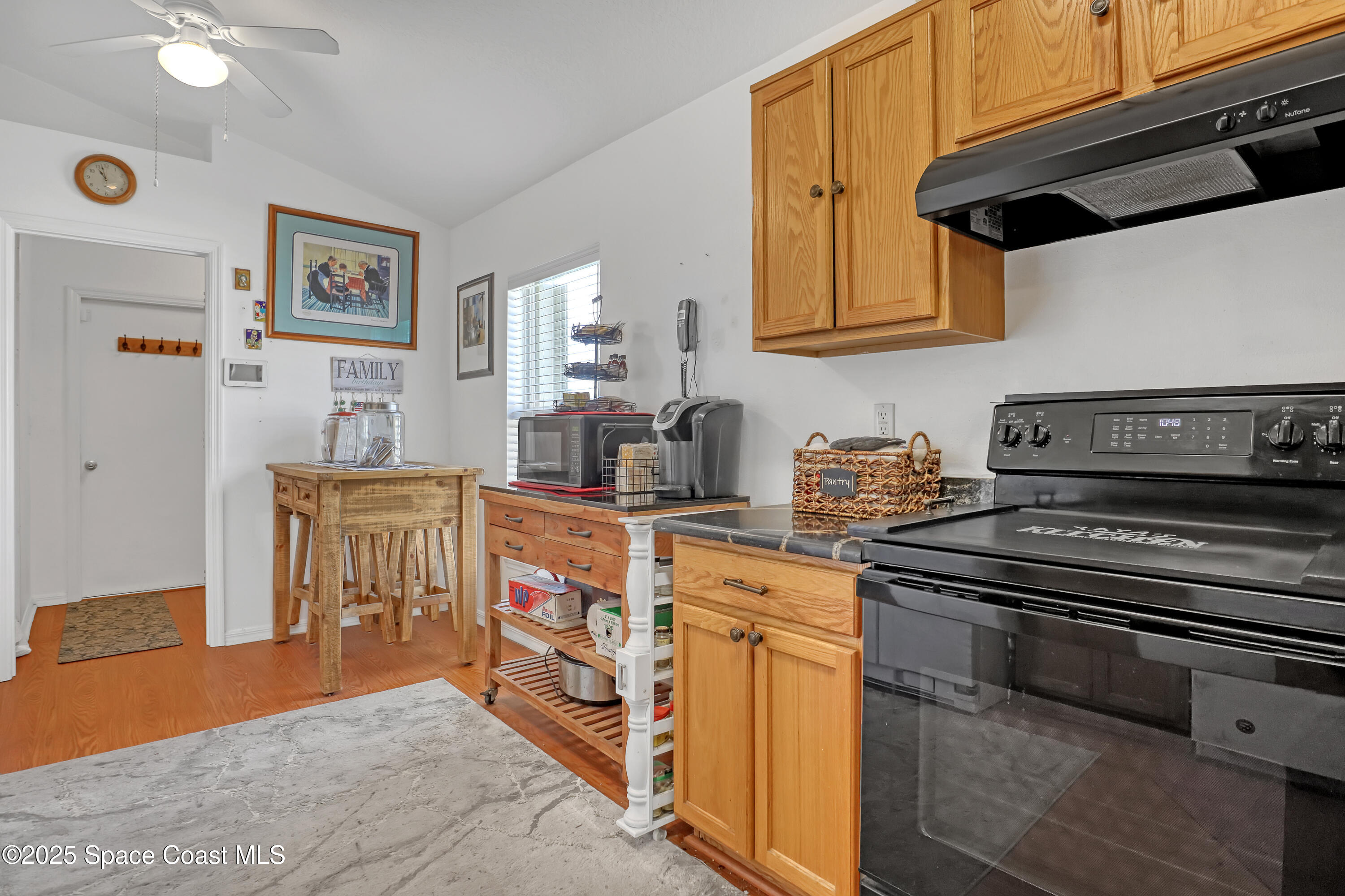 2210 Spring Creek Circle Palm Bay, FL 32905 - Photo 17 of 39 a kitchen with stainless steel appliances granite countertop a stove and a sink