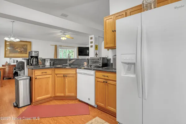 a kitchen with stainless steel appliances granite countertop a refrigerator and a stove top oven