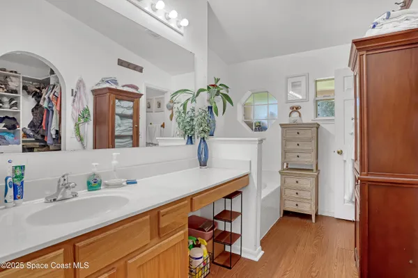 a spacious bathroom with a sink and a mirror