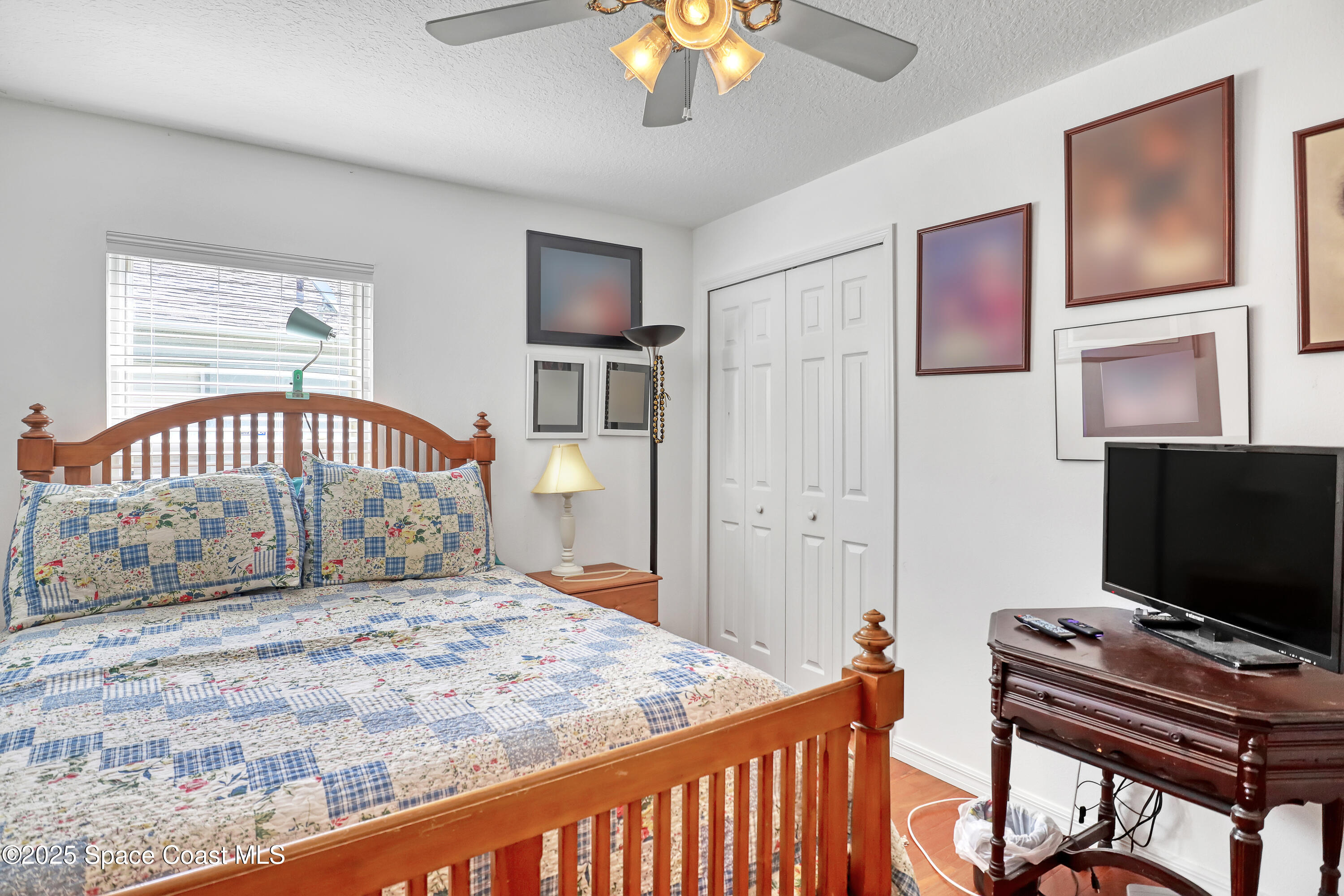 2210 Spring Creek Circle Palm Bay, FL 32905 - Photo 29 of 39 a bedroom with a bed and flat screen tv