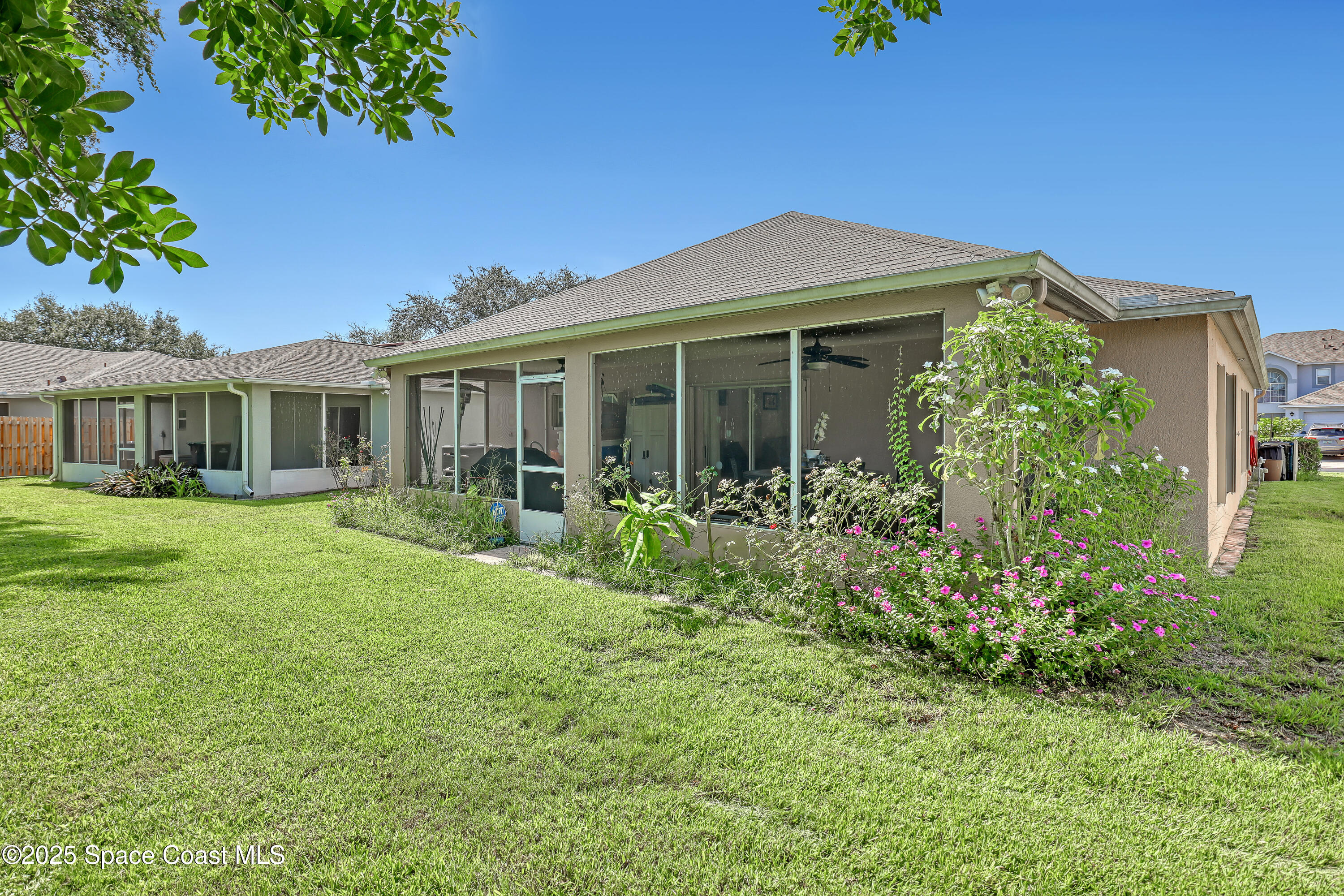 2210 Spring Creek Circle Palm Bay, FL 32905 - Photo 32 of 39 a front view of a house with a yard