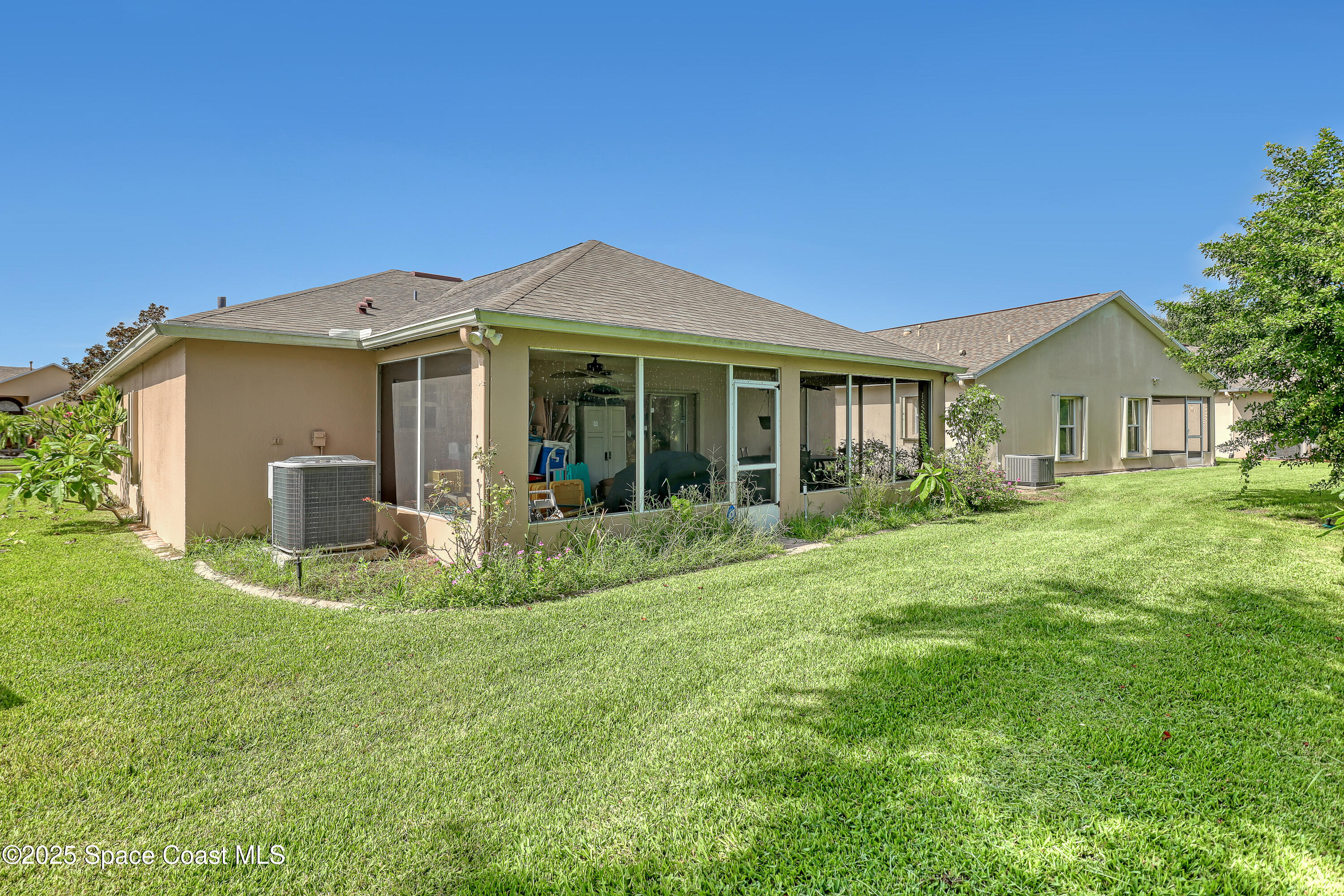 2210 Spring Creek Circle Palm Bay, FL 32905 - Photo 34 of 39 a view of a house with backyard and porch