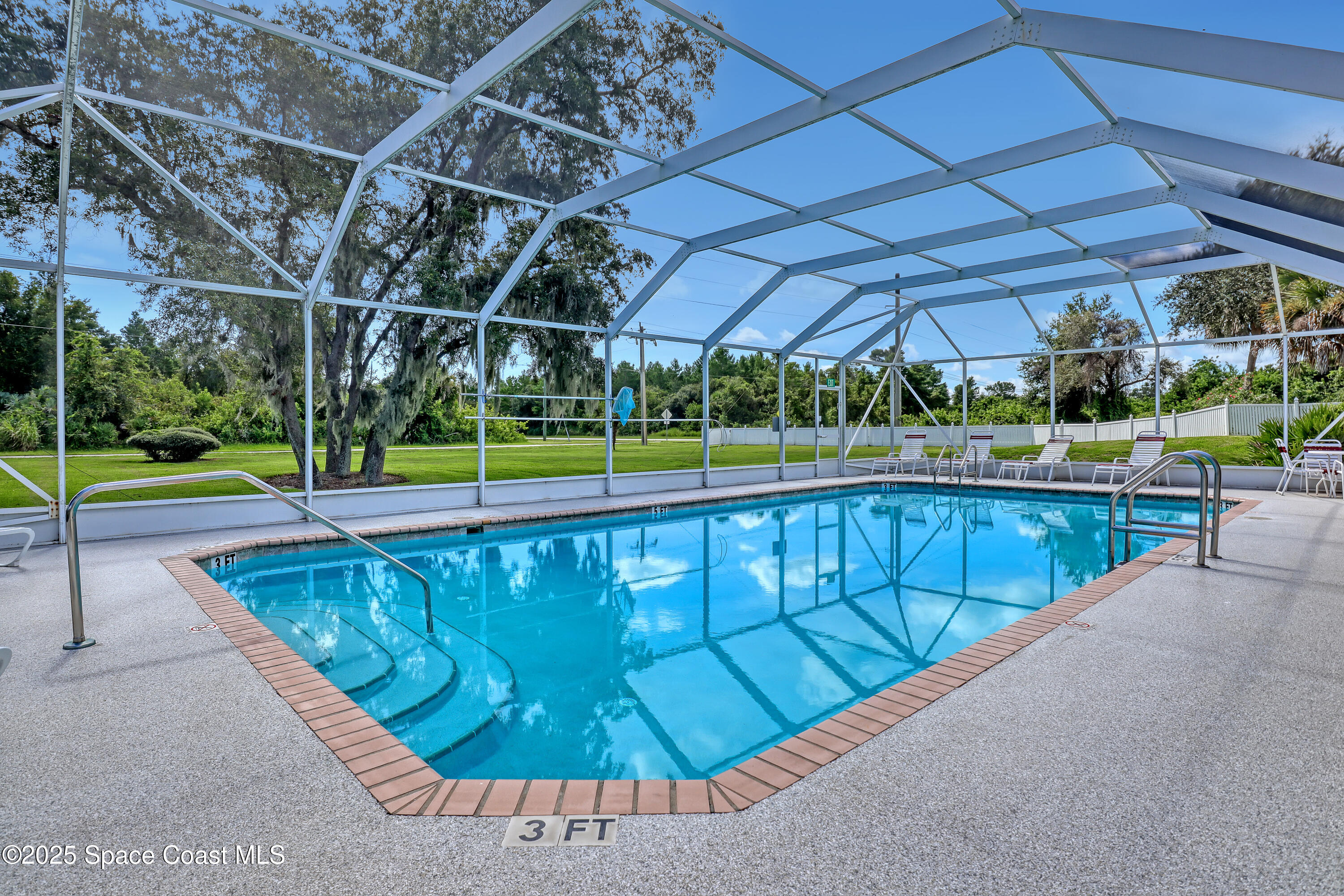 2210 Spring Creek Circle Palm Bay, FL 32905 - Photo 36 of 39 a view of a swimming pool with a patio and a yard