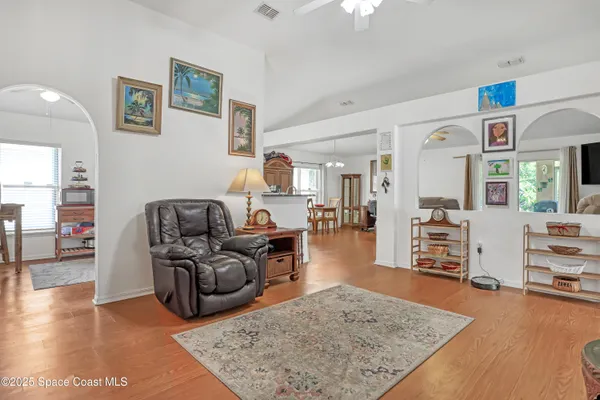 a living room with furniture and wooden floor