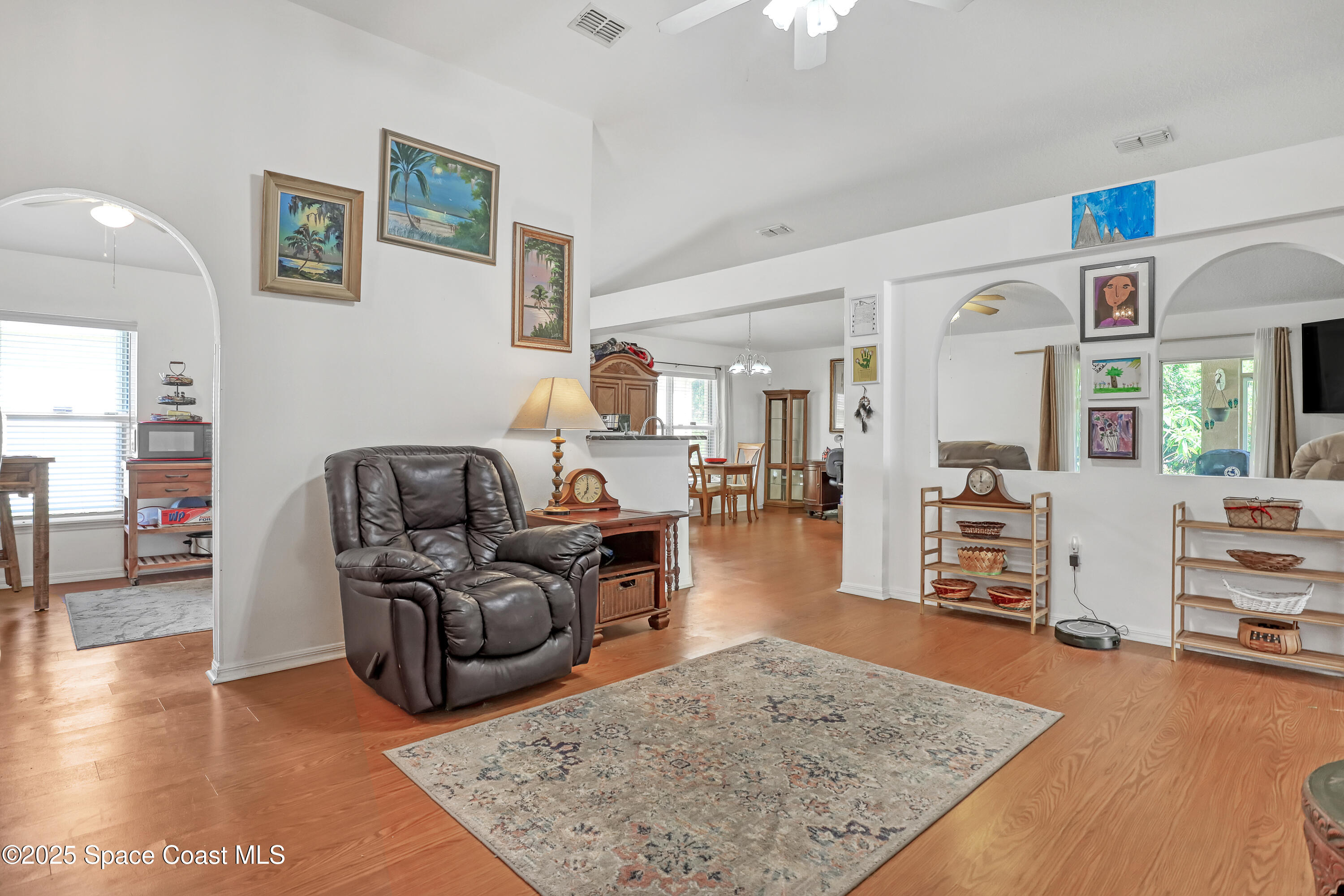 2210 Spring Creek Circle Palm Bay, FL 32905 - Photo 6 of 39 a living room with furniture and wooden floor