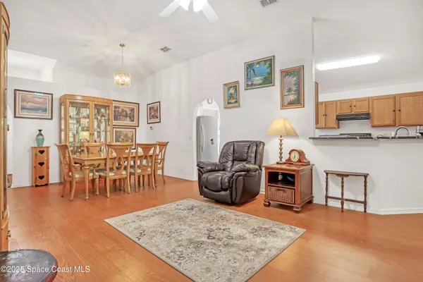 a living room with furniture a rug and a table