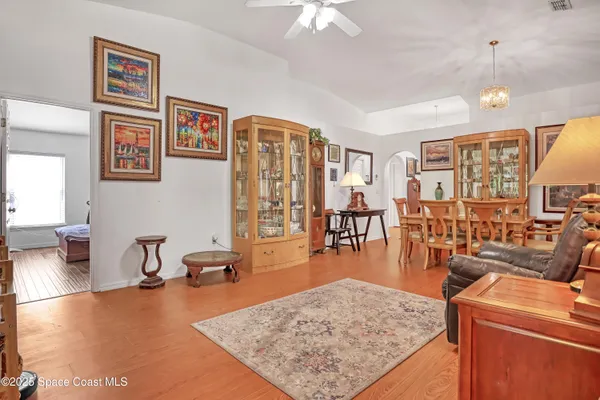 a living room with furniture and wooden floor