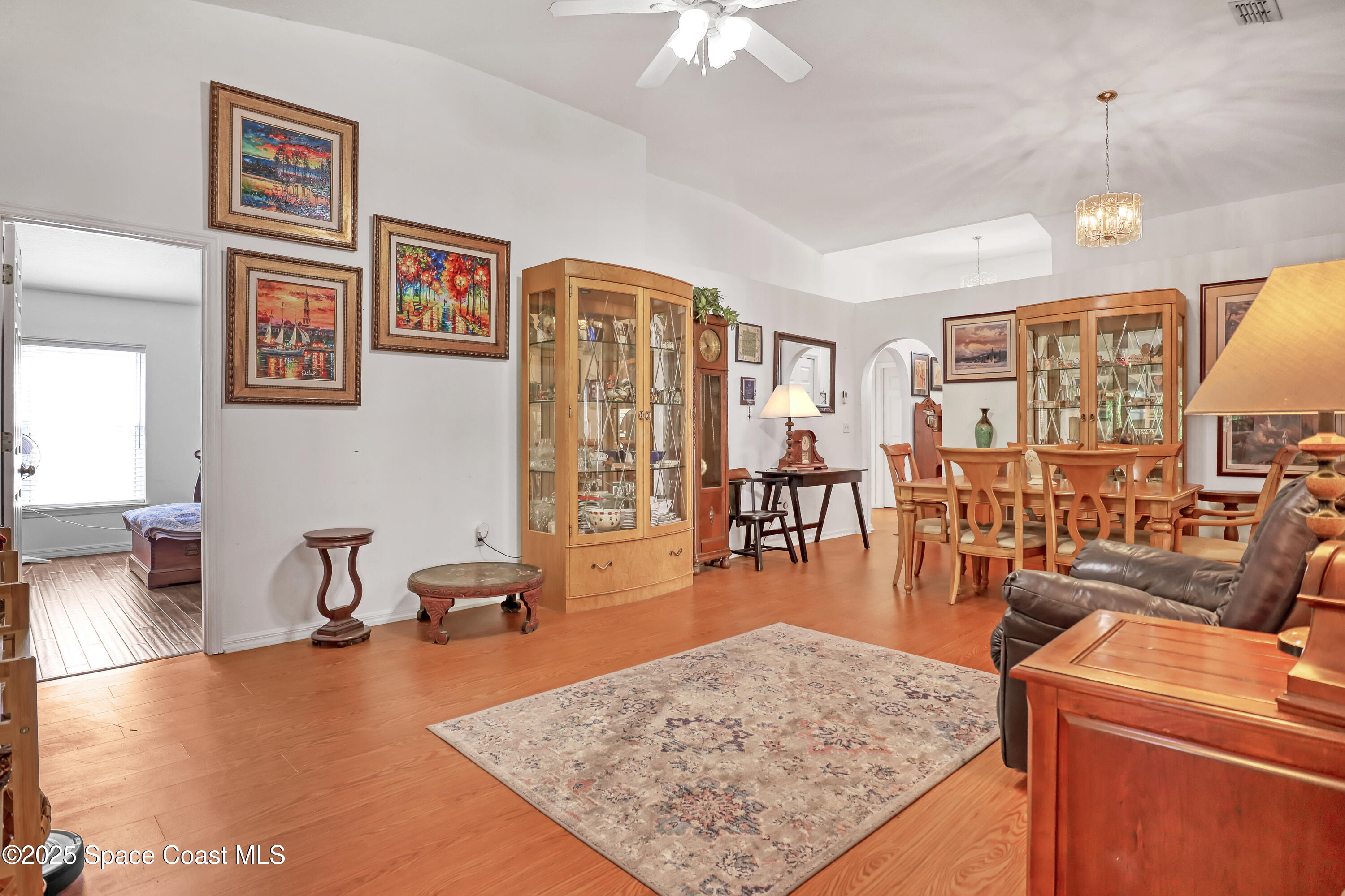 2210 Spring Creek Circle Palm Bay, FL 32905 - Photo 8 of 39 a living room with furniture and wooden floor