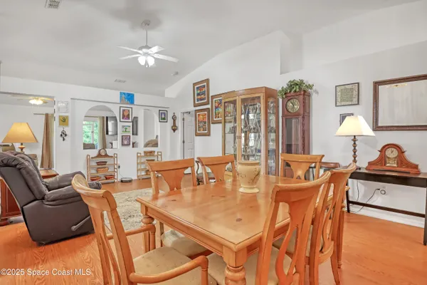 a dining room with furniture and wooden floor