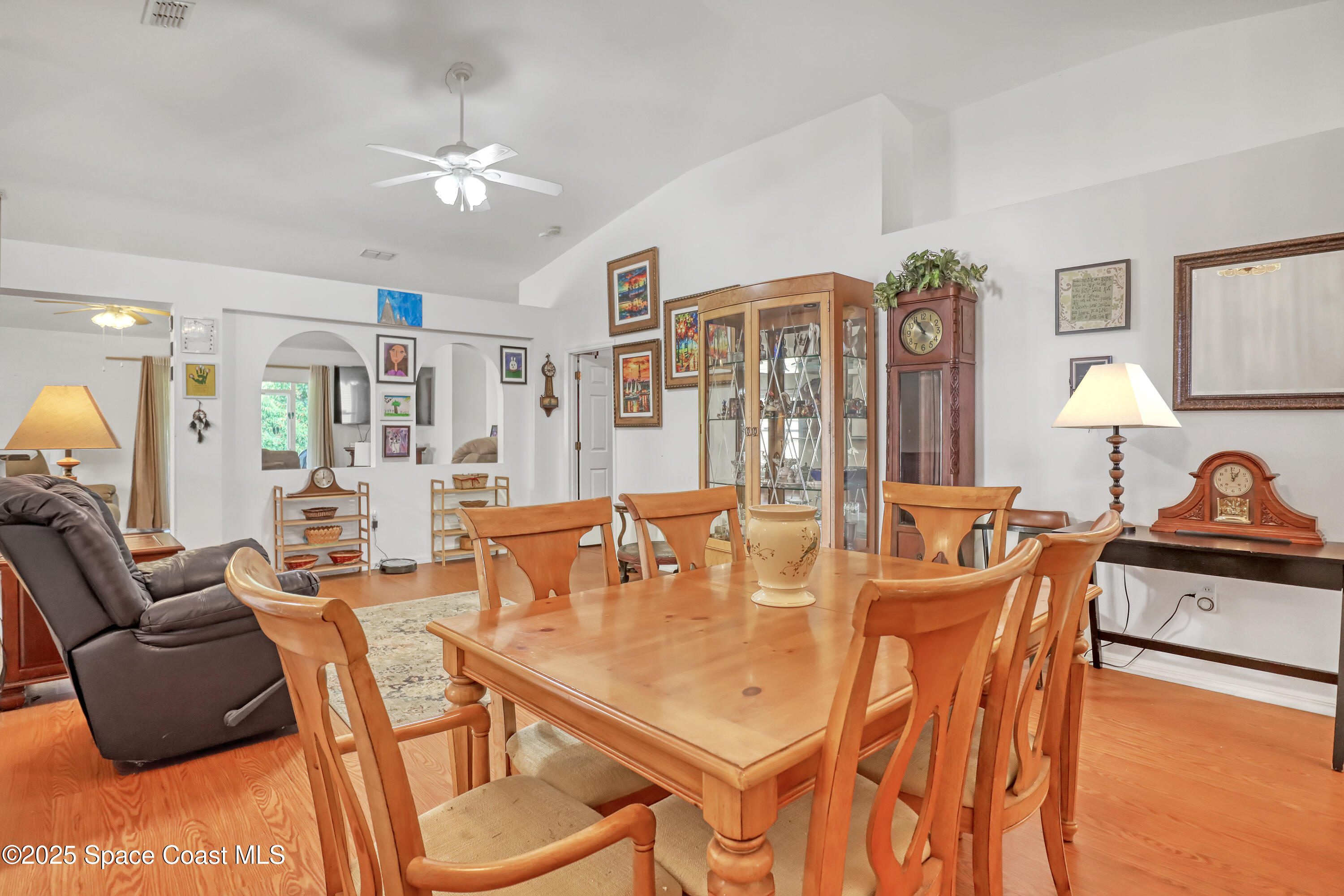 2210 Spring Creek Circle Palm Bay, FL 32905 - Photo 9 of 39 a dining room with furniture and wooden floor