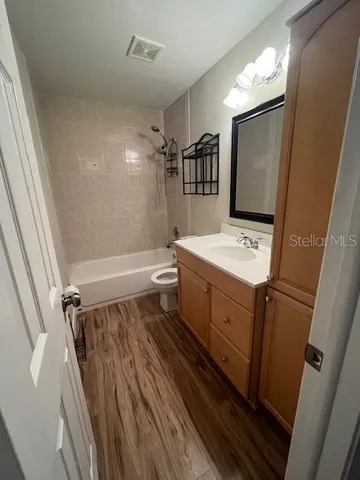 a kitchen with kitchen island a counter top space stainless steel appliances and a window