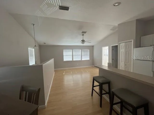 a utility room with wooden floor washer and dryer